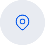 A blue location pin icon in the center of a light gray circular background.